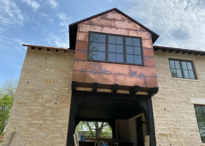 Copper metal panel facade on a stone building for Roof Repair in Kingsburg