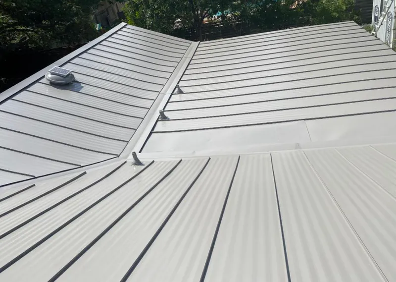 Solar attic fan installed on a metal roof for Roof Ventilation in Kingsburg